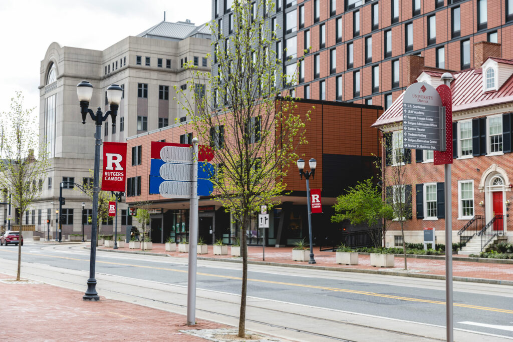 cooper street in camden with rutgers flags and alumni house